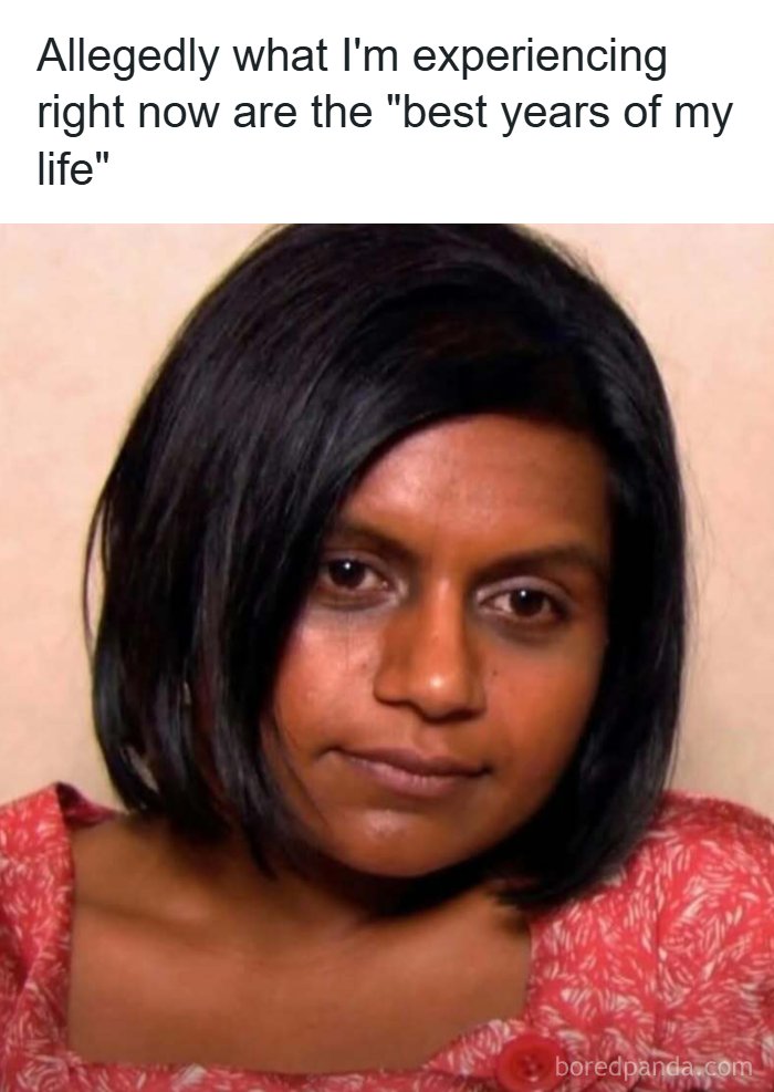 Woman with dark hair and tired eyes wearing red floral top, illustrating memes to handle reality with humor.