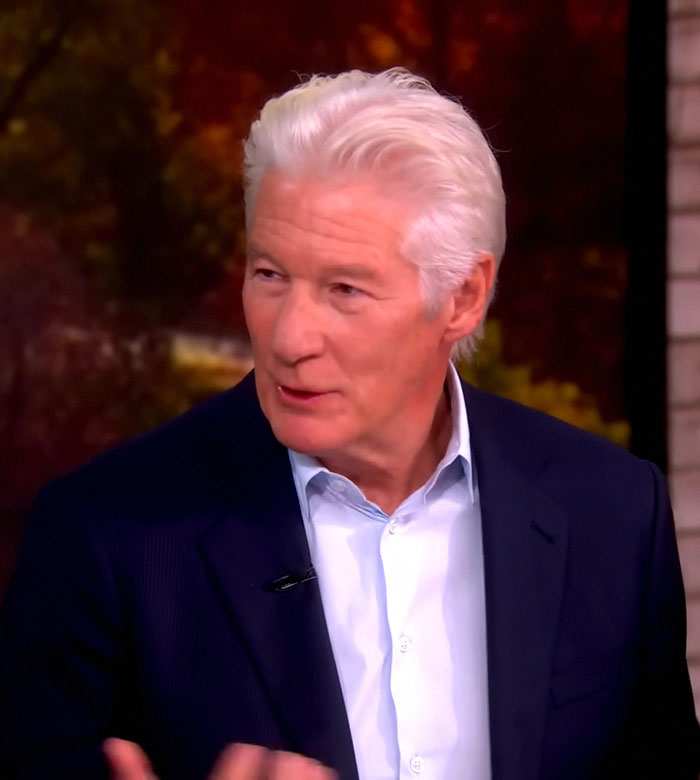 Richard Gere speaking in an interview, wearing a dark blazer and light blue shirt, discussing Oscars ban controversy. Richard Gere speaking in an interview, wearing a dark blazer and light blue shirt, discussing Oscars ban controversy.