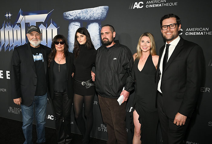 Group of six adults posing at an event, son eyed as person of interest after Rob Reiner and wife found slain in LA home Group of six adults posing at an event, son eyed as person of interest after Rob Reiner and wife found slain in LA home