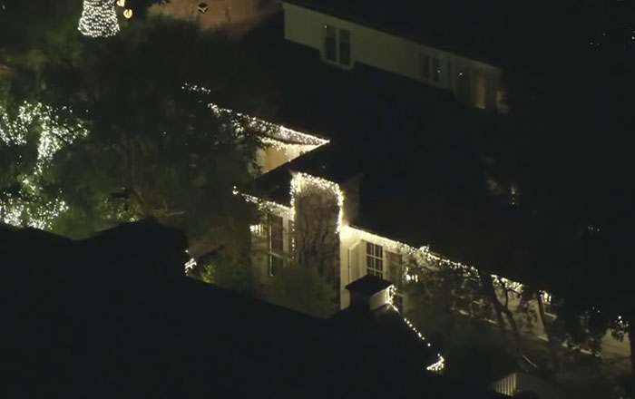 A large house lit with white holiday lights at night, related to son eyed as person of interest in LA case. A large house lit with white holiday lights at night, related to son eyed as person of interest in LA case.