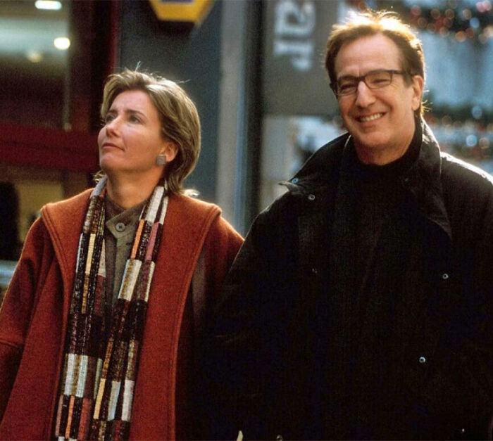 Scene from Love Actually featuring two characters smiling and walking outside in winter attire. Scene from Love Actually featuring two characters smiling and walking outside in winter attire.