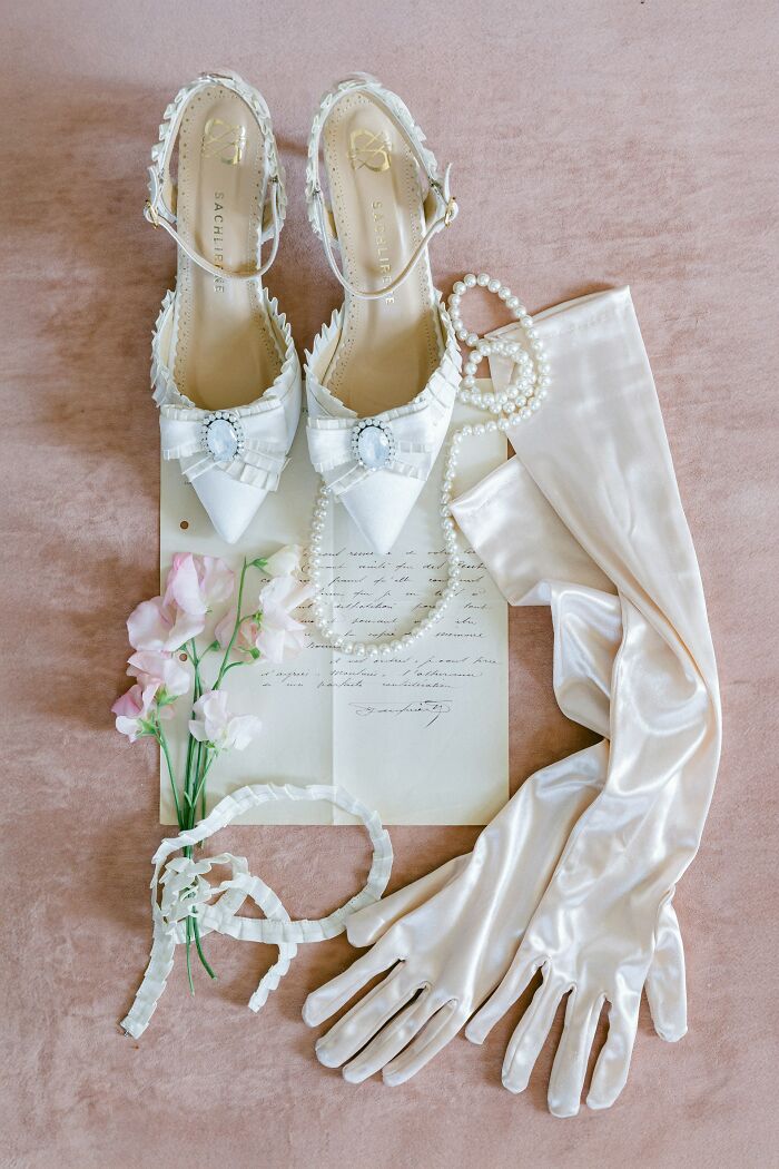 White vintage shoes, pearl necklace, long satin gloves, flowers, and a handwritten letter among lost things never claimed.
