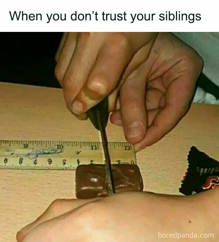 Close-up of hands cutting a small piece of chocolate with a ruler, illustrating sibling trust issues in memes about siblings.