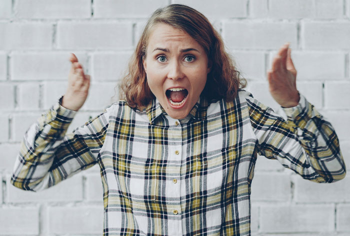 Angry woman expressing frustration and shocked by entitled behavior while trying to help her brother and his wife.