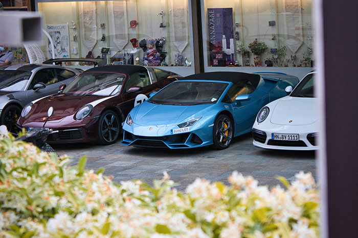Luxury cars parked on a city street, illustrating clever criminals who boldly outsmarted police officers with daring tactics.