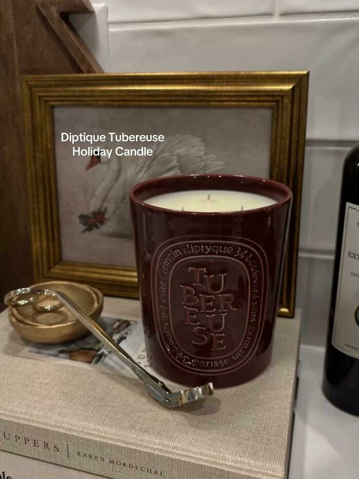 Diptyque Tubereuse holiday candle in a maroon jar displayed as a highly recommended Christmas gift.