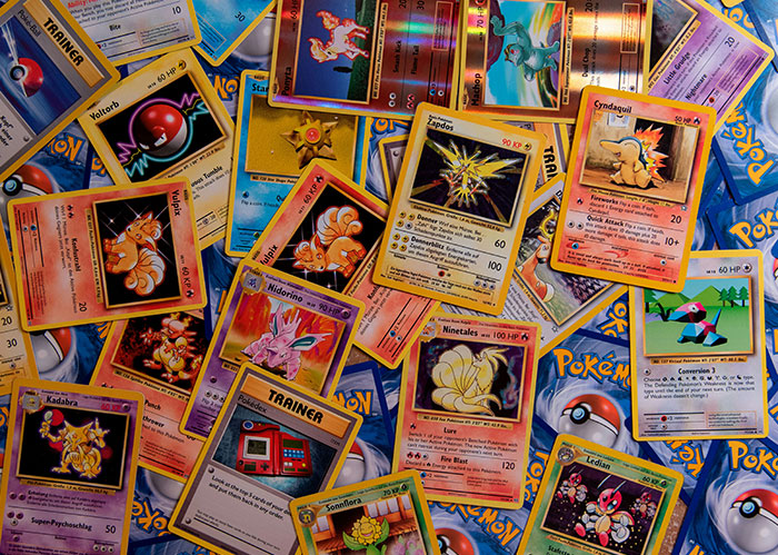 Assorted vintage Pokémon cards spread out, illustrating diabolical revenge stories and fierce enemies collection.
