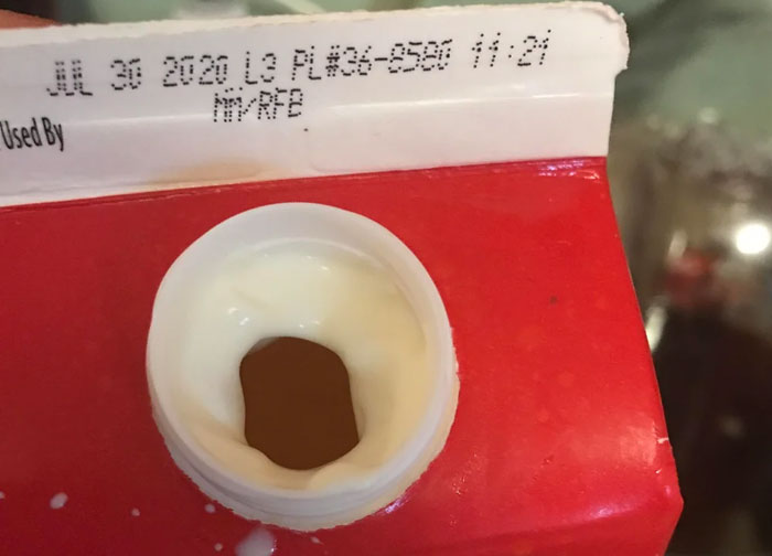 Milk carton with a damaged opening preventing proper pouring, illustrating a diabolical revenge story experience.