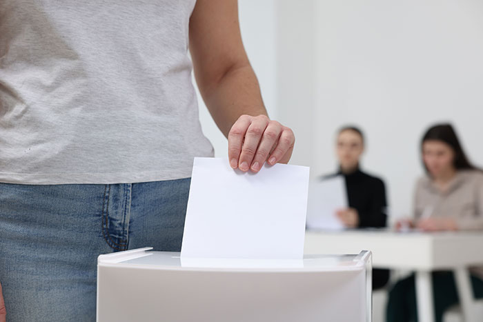 Person casting a vote at a polling station, illustrating things people never took seriously until experienced themselves.