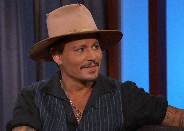 Man wearing a brown hat and striped shirt during an interview, sharing vibes celebrities gave off when met.