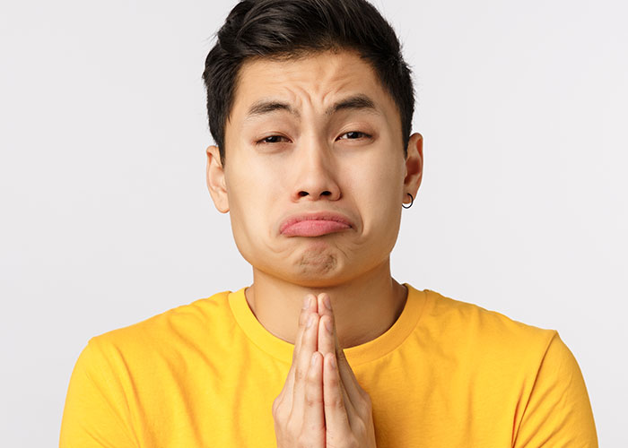 Young man in yellow shirt pleading with a distressed expression, relating to a cruel prank and family reaction. Young man in yellow shirt pleading with a distressed expression, relating to a cruel prank and family reaction.