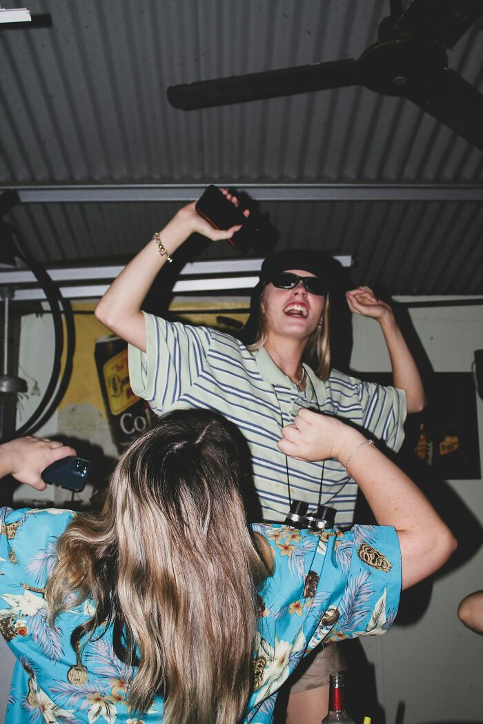 Two friends dancing and having fun indoors, highlighting chaotic best friend moments and close friendships. Two friends dancing and having fun indoors, highlighting chaotic best friend moments and close friendships.