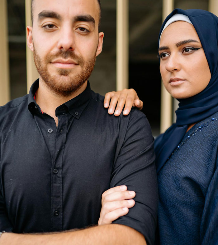 Young man and woman with serious expressions, capturing the dynamic of secretly gay teen and homophobic parents. Young man and woman with serious expressions, capturing the dynamic of secretly gay teen and homophobic parents.