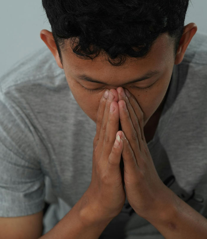 Teen with hands clasped in reflection, illustrating the secretly gay teen teaching homophobic parents a lesson on respect. Teen with hands clasped in reflection, illustrating the secretly gay teen teaching homophobic parents a lesson on respect.