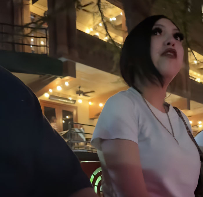 Teen taught harsh lesson by judge after pepper-spraying tourists on a boat, standing in dimly lit outdoor setting.