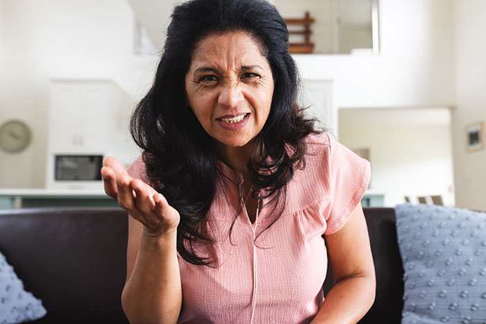 Woman showing frustration and anger in a home setting, illustrating teen’s struggle with stepmother insecurity issues. Woman showing frustration and anger in a home setting, illustrating teen’s struggle with stepmother insecurity issues.