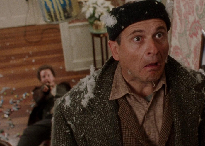 Man with shocked expression during a chaotic scene in Home Alone, highlighting viral then-and-now moments for millennials.
