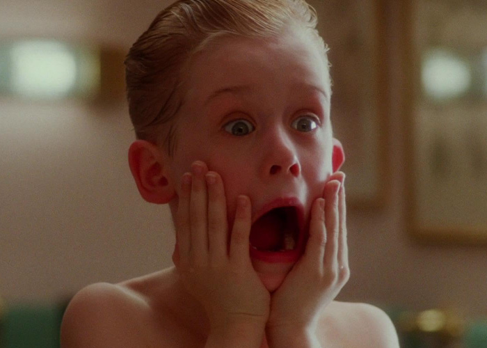 Young boy from Home Alone movie with a shocked expression holding his face, symbolizing viral millennials existential crisis.