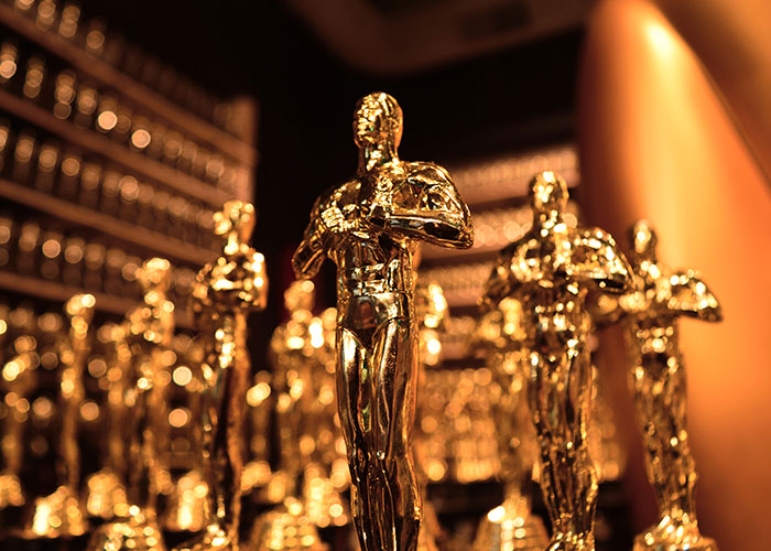 Golden statuettes displayed on a shelf, shining under warm lighting, representing interesting today I learned facts collection.