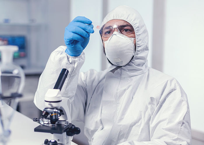 Scientist in protective gear examining a sample in lab, illustrating interesting today I learned facts about science and health.