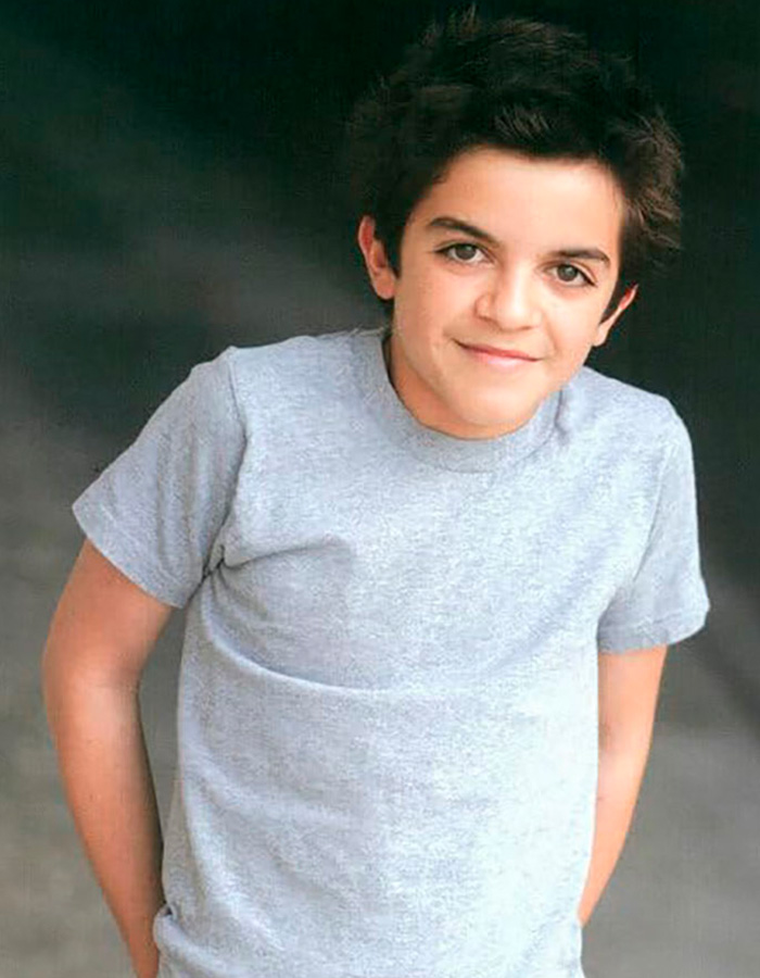 Young former child actor Tylor Chase in a gray t-shirt posing with a slight smile against a dark background. Young former child actor Tylor Chase in a gray t-shirt posing with a slight smile against a dark background.