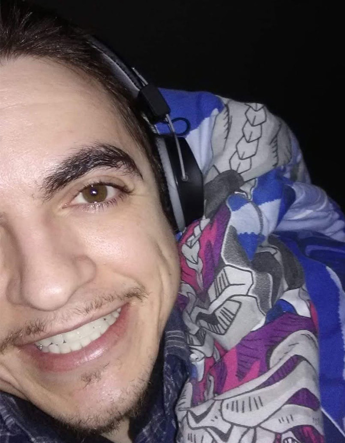 Close-up of former child actor Tylor Chase smiling with headphones and colorful blanket, hinting at recent troubles. Close-up of former child actor Tylor Chase smiling with headphones and colorful blanket, hinting at recent troubles.