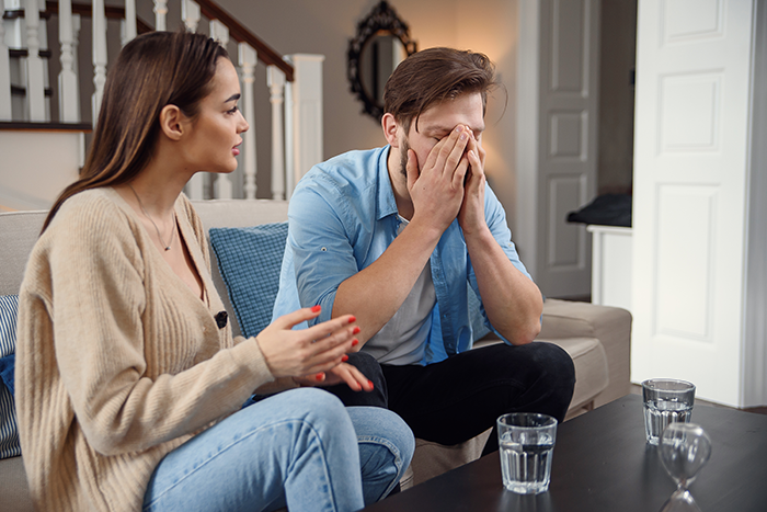 Bride and groom in a tense conversation at home, reflecting on betrayal and cheating before their wedding vows.