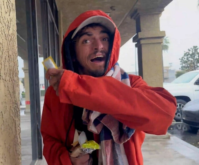 Man in red hoodie and scarf outdoors, holding snacks, linked to Tylor Chase’s hospitalization and friend’s revelation. Man in red hoodie and scarf outdoors, holding snacks, linked to Tylor Chase’s hospitalization and friend’s revelation.