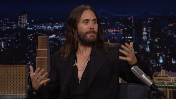 Actor with long hair and beard speaking on a late-night show, illustrating people think celebrities closet skeletons.