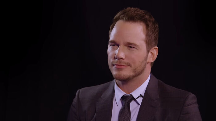 Man in a suit and tie sitting and reflecting, illustrating the idea of celebrities and their closet skeletons.