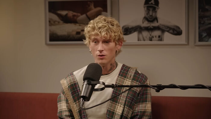 Blonde man speaking into a microphone during a podcast recording about people think celebrities closet skeletons.