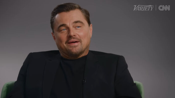 Actor in a black suit speaking in an interview about people think celebrities closet skeletons on CNN and Variety.