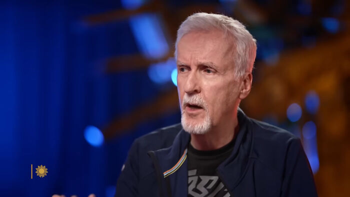 Older man with white hair and beard speaking during an interview, sharing fascinating secrets about celebrities from past colleagues.