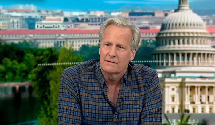 Man in a checkered shirt discussing his once famous regular job with the Capitol building visible in the background.