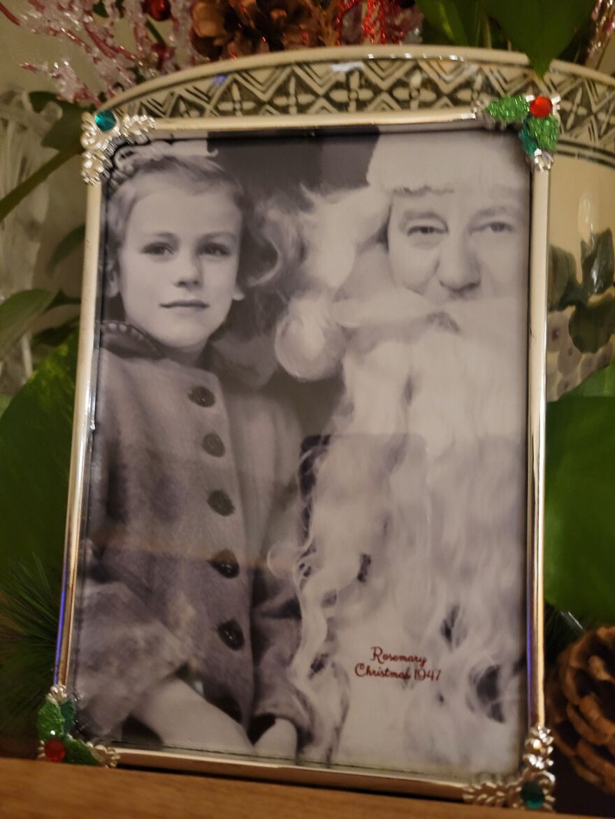 Vintage Christmas decoration featuring a black and white photo of a child with Santa Claus from 1947.