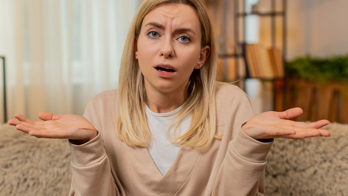 Woman confused and frustrated indoors as avid walker mocked by sister-in-law for doing 20K steps per day