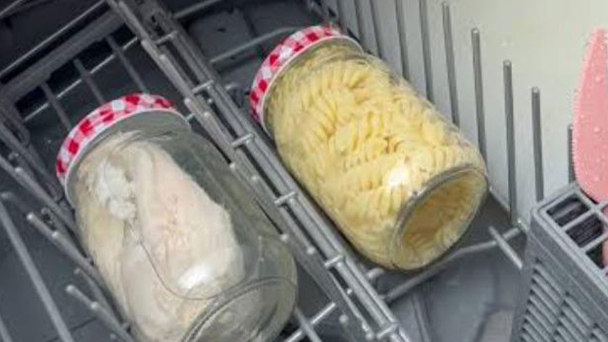 Two jars filled with food placed inside a dishwasher rack, illustrating cooking food in the dishwasher method.