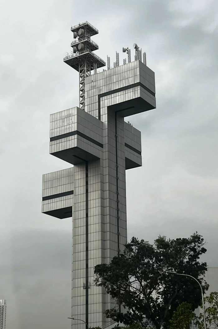 Futuristic building with blocky extensions and antennas, an example of weirdest buildings from around the world.