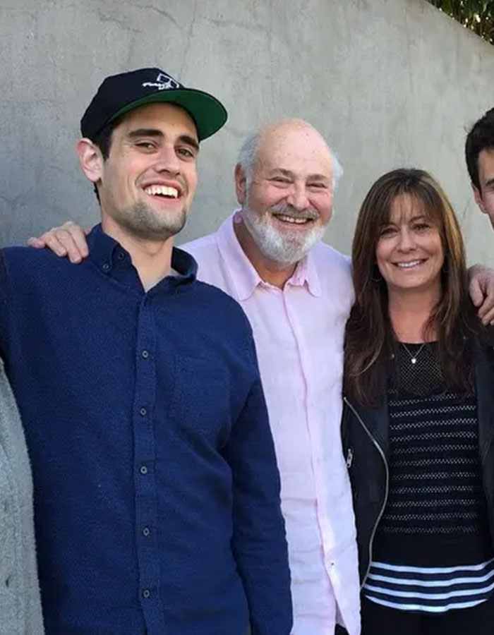 Group of people smiling at an outdoor event, related to Rob Reiner's son and celebrities at Conan O'Brien's party. Group of people smiling at an outdoor event, related to Rob Reiner's son and celebrities at Conan O'Brien's party.