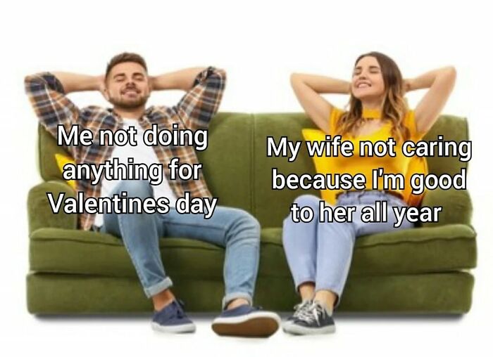 Couple relaxing on a green couch, sharing a sweet and wholesome moment about Valentine’s Day care and appreciation.