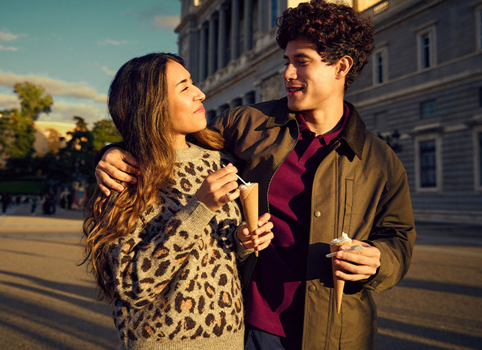 Young couple enjoying ice cream outdoors, illustrating a daughter treating boyfriend like a personal ATM concept.