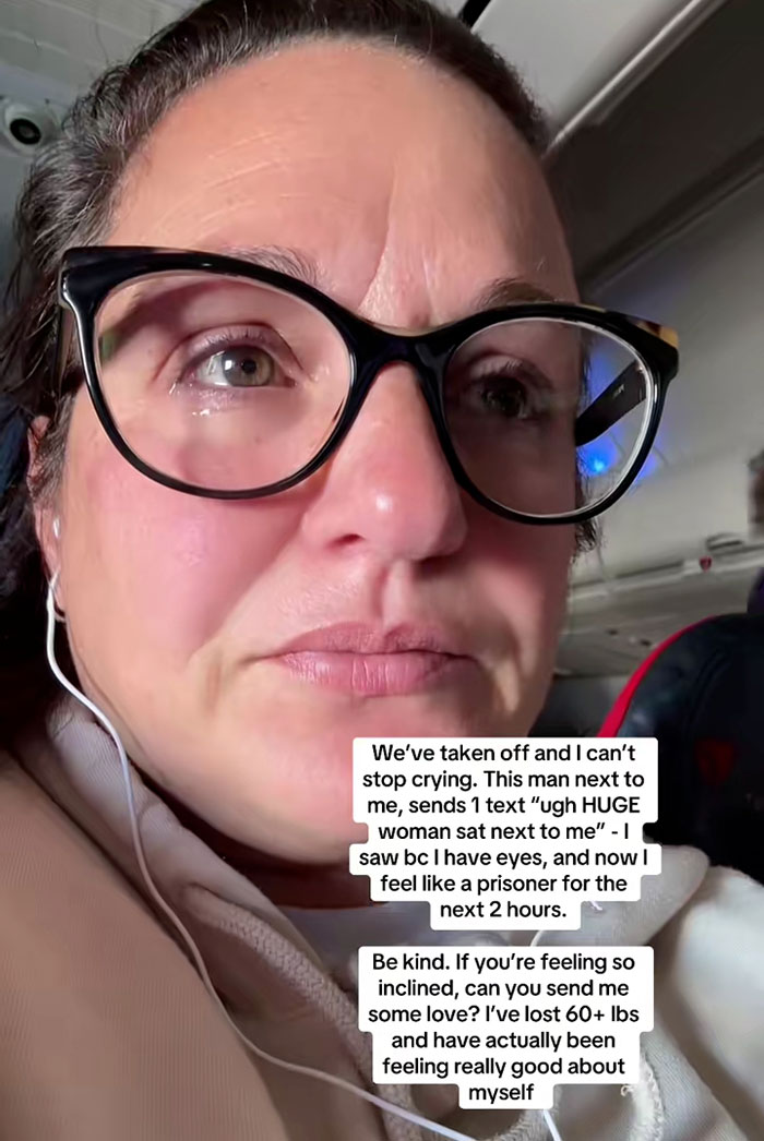 Woman crying on flight after reading seatmate's body-shaming text, highlighting impact of weight discrimination and kindness needed.