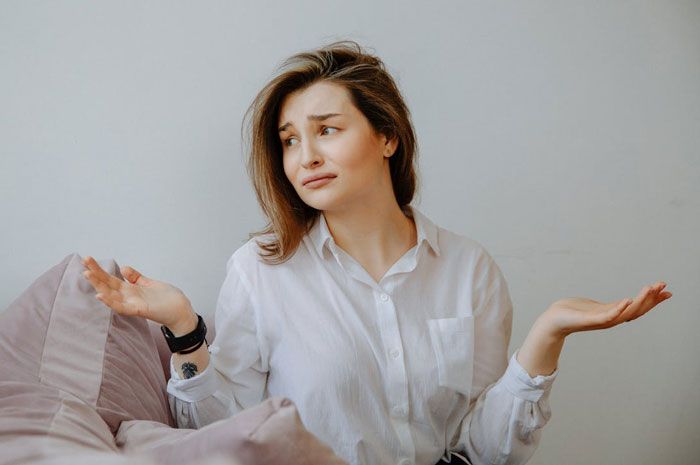 Woman looking confused and distressed sitting on a couch, representing proof of cheating and crazy ex-girlfriends. Woman looking confused and distressed sitting on a couch, representing proof of cheating and crazy ex-girlfriends.