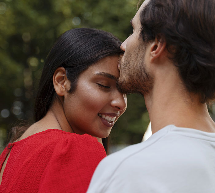 Couple sharing an intimate moment outdoors, illustrating future in-laws demanding a prenup then backtracking on the demand. Couple sharing an intimate moment outdoors, illustrating future in-laws demanding a prenup then backtracking on the demand.