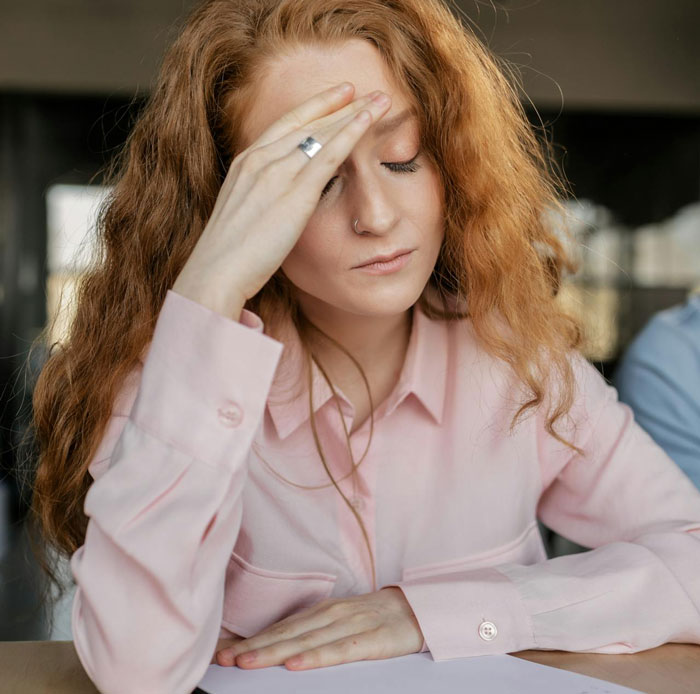 Woman feeling stressed and overwhelmed, holding forehead while dealing with stepdaughter’s behavior and in-laws’ comments. Woman feeling stressed and overwhelmed, holding forehead while dealing with stepdaughter’s behavior and in-laws’ comments.