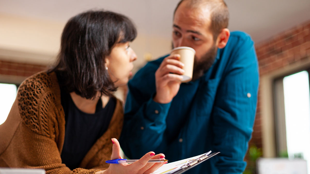 Woman and man having serious discussion indoors, reflecting on divorce and regret after relationship ends.