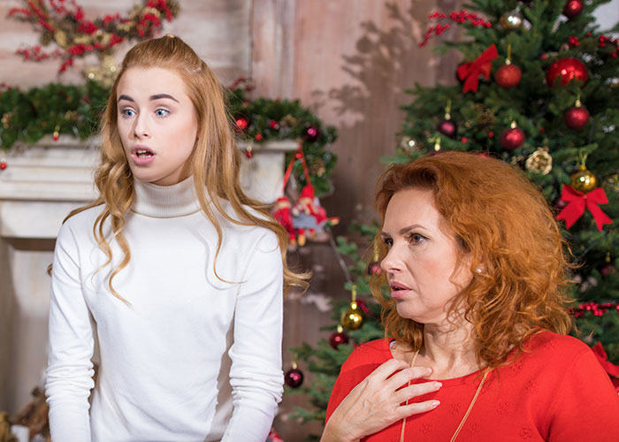 Mom looking shocked and worried during Christmas, highlighting the stress of running away from her kids on holiday.
