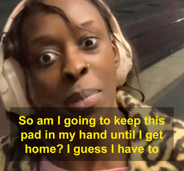 Woman wearing headphones with a determined expression, holding a period pad to scare off men stalkers for safety. Woman wearing headphones with a determined expression, holding a period pad to scare off men stalkers for safety.