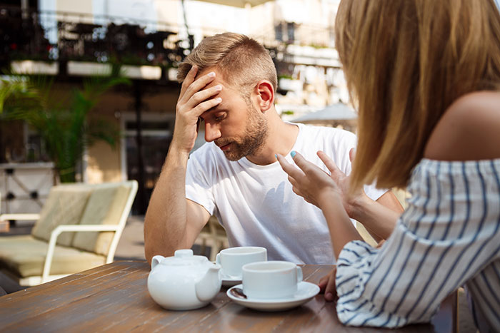 Man venting about traditional wives, looking frustrated while woman gestures during a tense conversation outdoors. Man venting about traditional wives, looking frustrated while woman gestures during a tense conversation outdoors.
