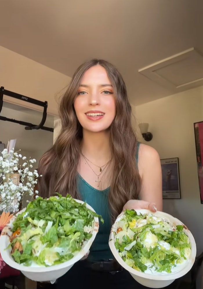 Young woman testing Chipotle food portions in orders placed under male names, holding two bowls with fresh ingredients. Young woman testing Chipotle food portions in orders placed under male names, holding two bowls with fresh ingredients.